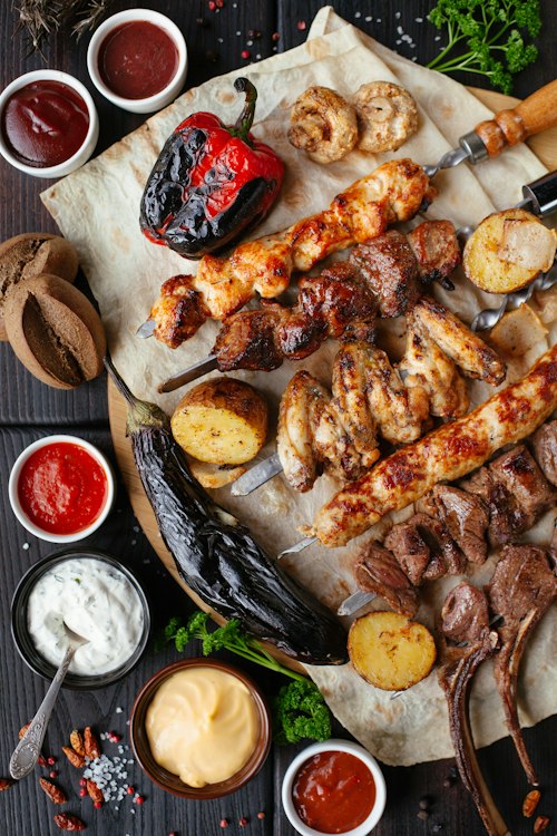 A generous platter of charcoal-grilled kebabs, vegetables and house dips